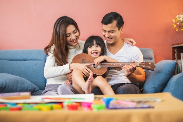 Portrait happy Asian family over red background