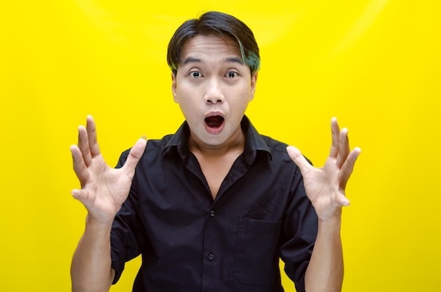 Portrait of happy asian man in black tshirt eats instant noodles using chopsticks and bowl