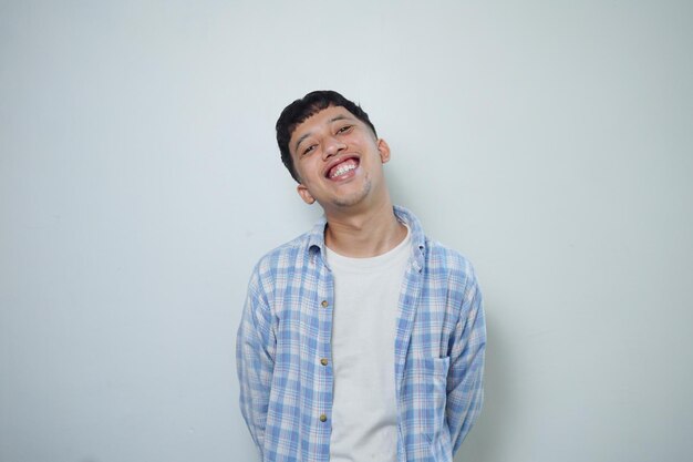 Portrait of happy Asian man in blue tshirt on isolated white background