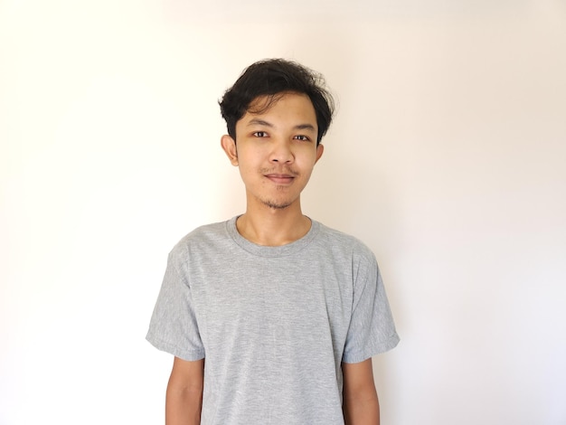 Portrait of happy Asian man in grey tshirt on isolated white background