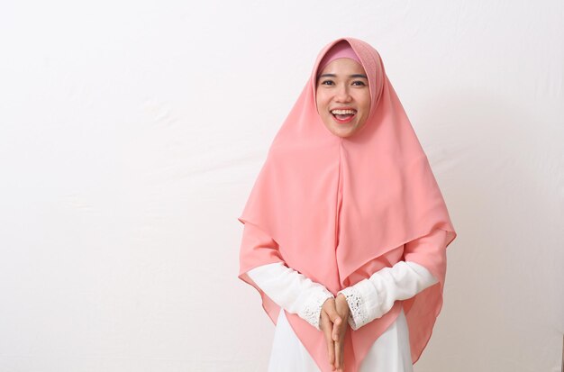 A portrait of happy asian muslim woman wearing a veil or hijab\
smiling and looking at camera. isolated on white background with\
copy space