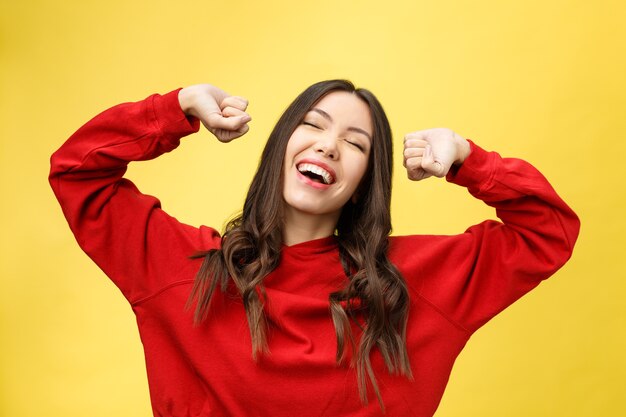 Portrait of a happy asian woman dancing isolated