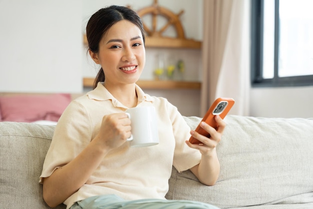 Portrait of a happy asian woman relaxing at home