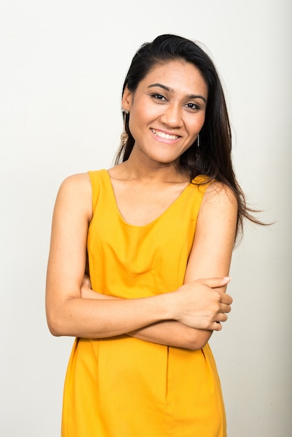 Portrait of happy Asian woman smiling with arms crossed