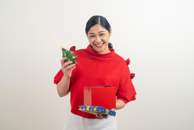 portrait happy Asian woman wearing red shirt with gift box on hand for Christmas festival