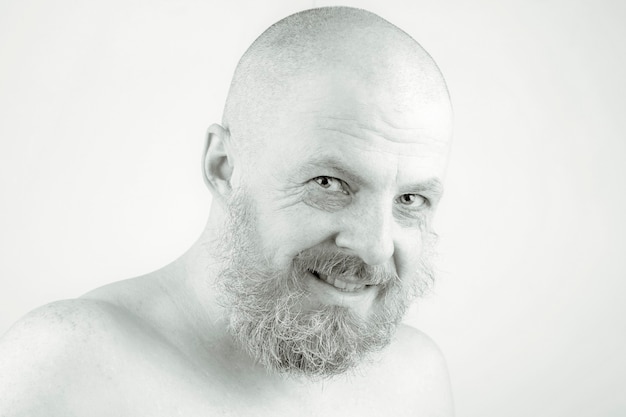 Photo portrait of a happy bearded man in soft lighting. human existence and calm