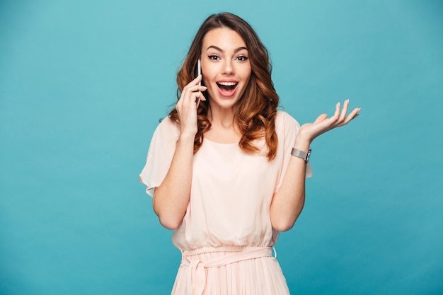 Portrait of a happy beautiful girl wearing dress talking