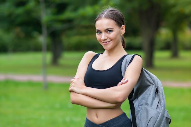 Portrait of happy beautiful positive fit girl, young slim fitness sports woman in sportswear, top