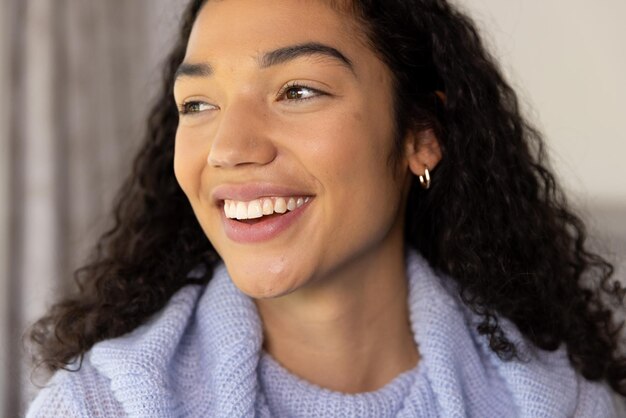 Portrait of happy biracial woman at sunny home