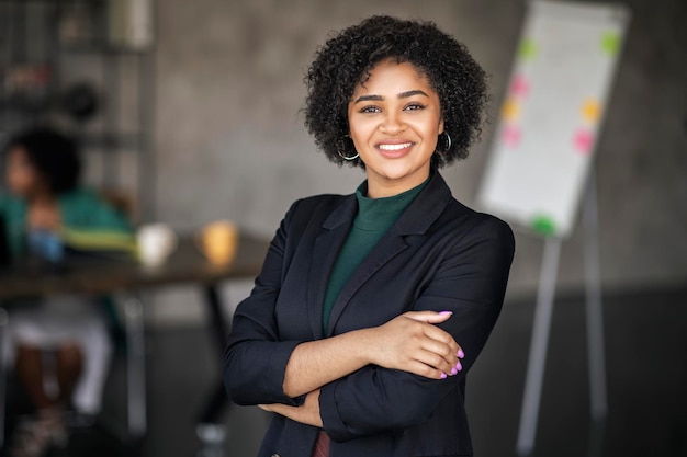 Portrait of happy black businesswoman smiling standing at modern office