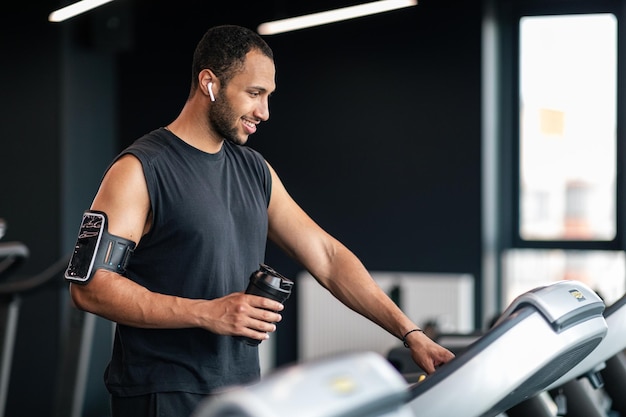 Portrait Of Happy Black Male Athlete Exercising On Treadmill At Gym