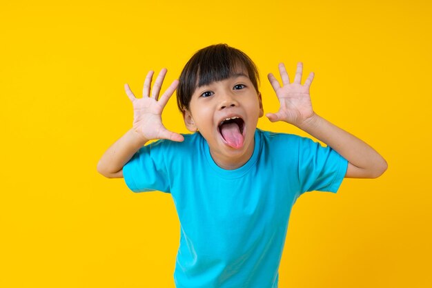 Portrait of happy boy against yellow background