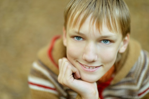 Portrait of happy boy in autumn park