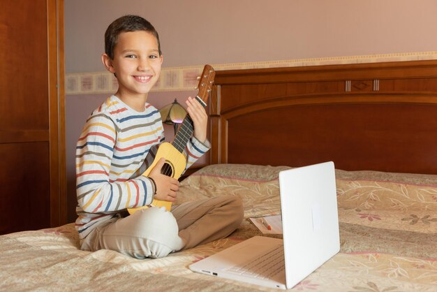 Portrait of happy boy on bed at home