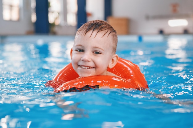 Portrait of happy boy swimming in pool