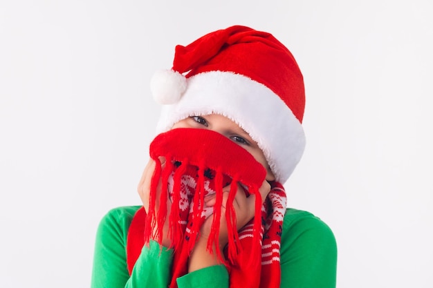 Portrait of happy boy wearing Santa Claus hat and winter scarf Merry Christmas time