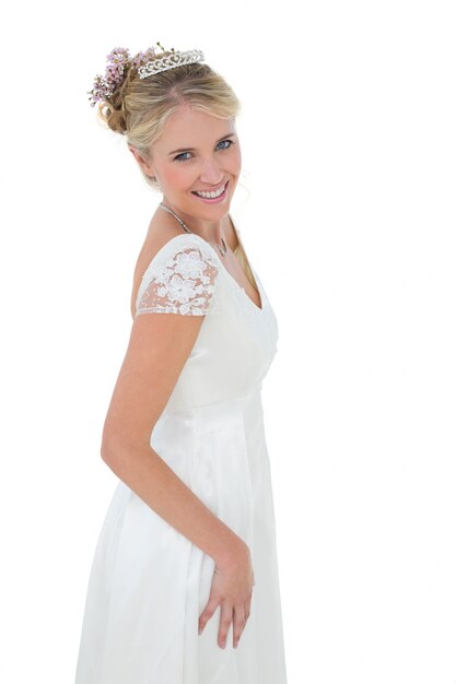 Portrait of happy bride standing against white background