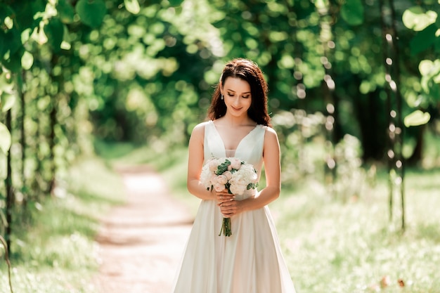 Portrait of a happy bride standing under an arch in the Park. events and traditions