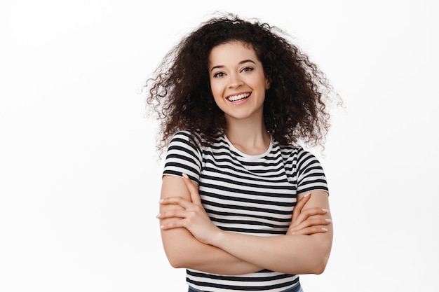 Photo portrait of happy brunette curly woman on white