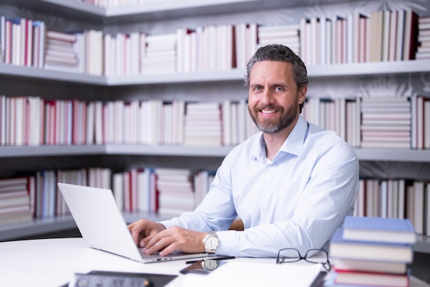 Portrait of happy business man in library handsome business man in office business man giving classe