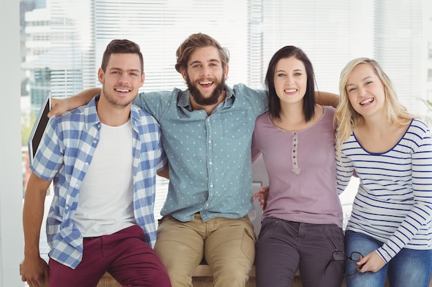 Portrait of happy business people with arm around 