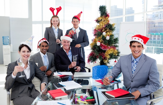 Portrait of a happy business team toasting with Champagne at a Christmas party