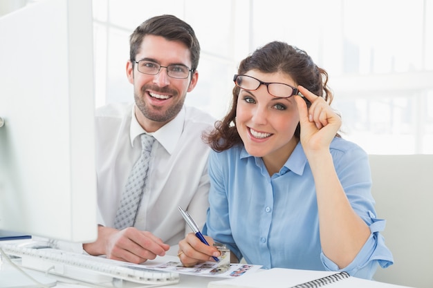 Portrait of happy business team with glasses in the office