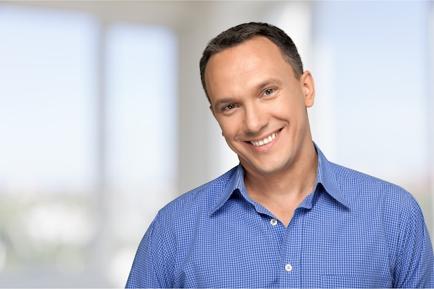 Portrait of happy businessman on background