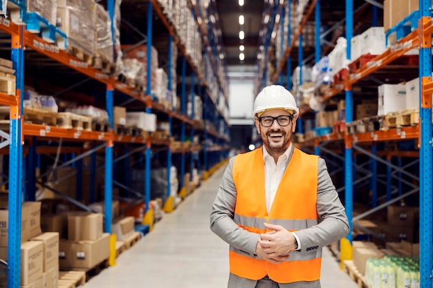 Portrait of a happy businessman posing in storage