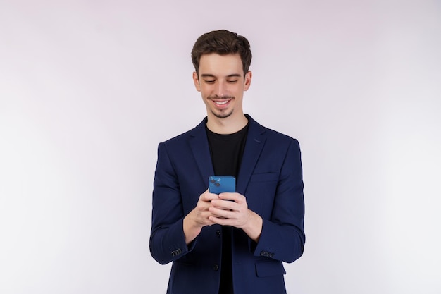 Portrait of a happy businessman using smartphone over white background