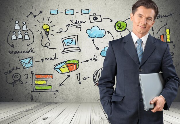 Portrait of happy businessman with icons and laptop  on background