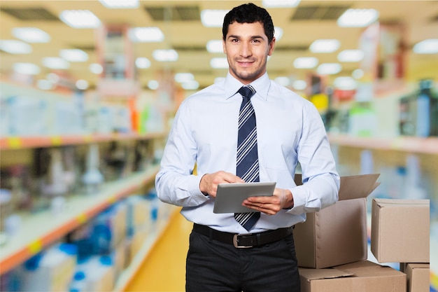 Portrait of happy businessman  with tablet pc on background