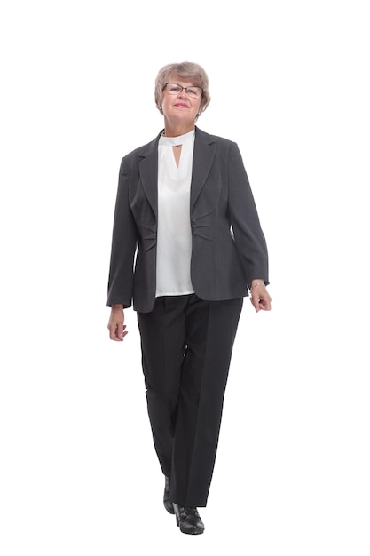Portrait of happy businesswoman walking on white background