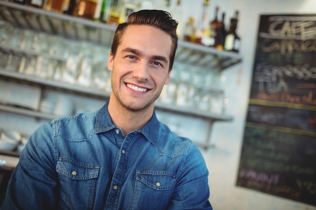 Portrait of happy cafe owner