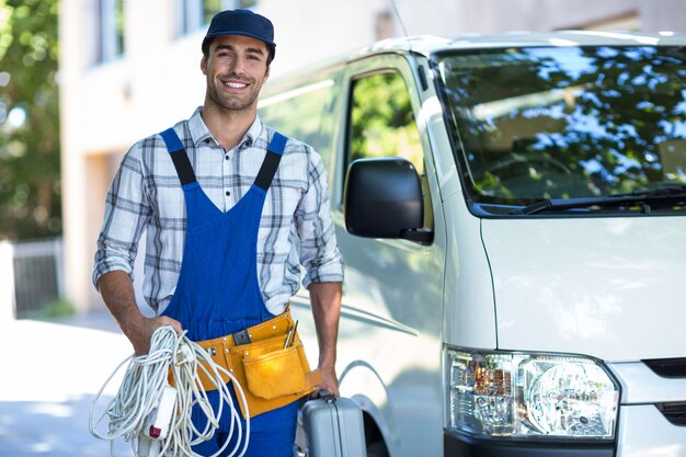 Portrait of happy carpenter with toolbox 