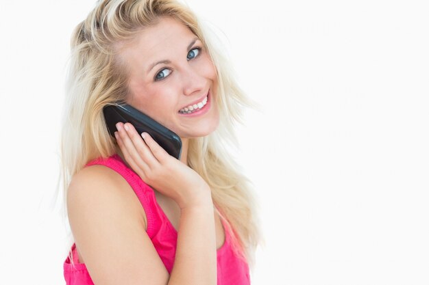 Portrait of happy casual young woman on call