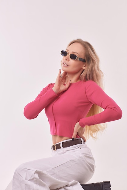 Portrait of happy charming cheerful blonde young girl smiles looking happy and glad lively with natural makeup tanned dressed in casual long sleeve tshirt