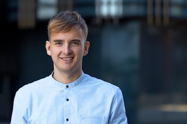 Portrait of a happy cheerful handsome male businessman with looking directly at the camera