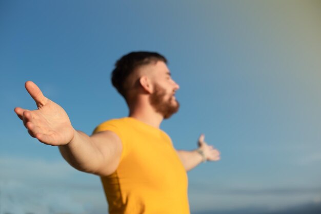 Portrait of happy cheerful positive guy young handsome bearded man with beard is enjoying sunny day