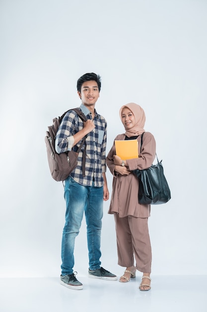 Portrait of Happy College Friend carrying a bag and book on an isolated white