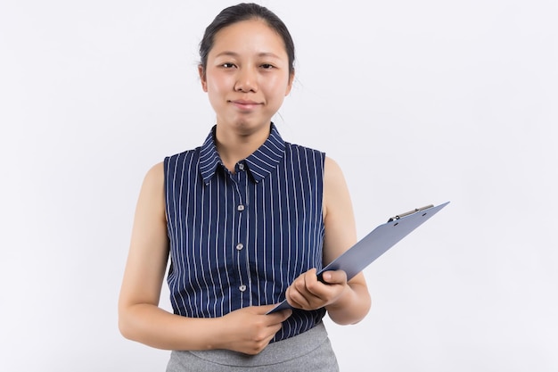 Portrait of happy confident businesswoman holding application book in office