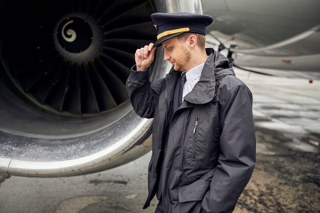 Portrait of happy confident caucasian airplane crew near plane