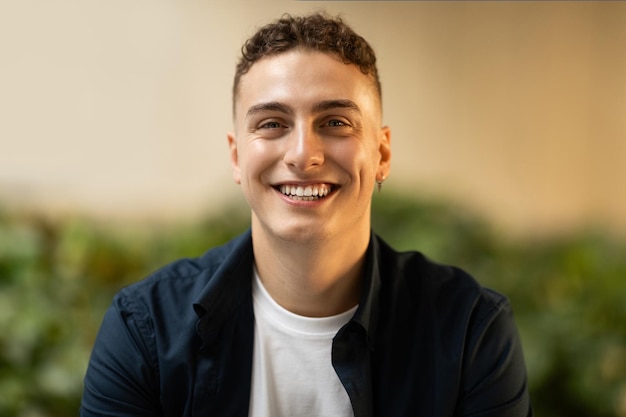 Portrait of happy confident young european man student freelancer in casual