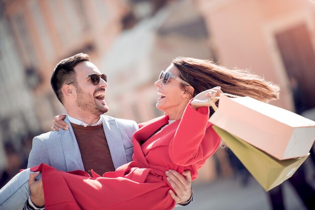 Portrait of happy couple after successful shopping