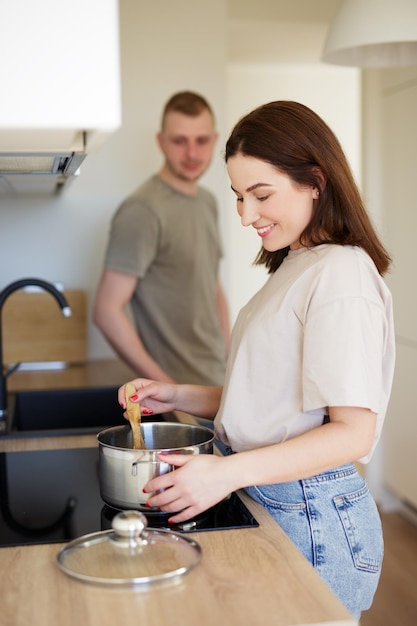 portrait of happy couple cooking together in modern kitchen