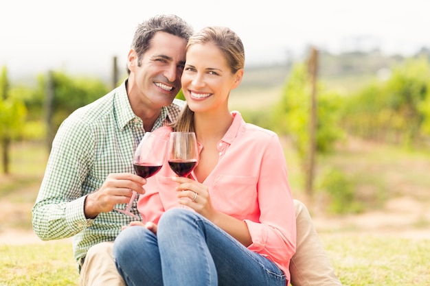 Portrait of happy couple holding glasses of wine