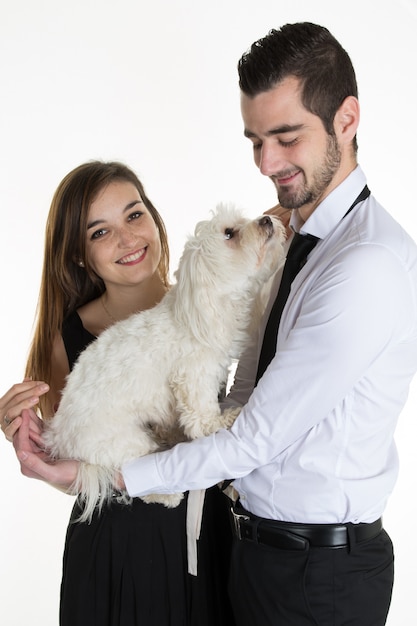 Foto ritratto delle coppie felici con il cane sopra bianco