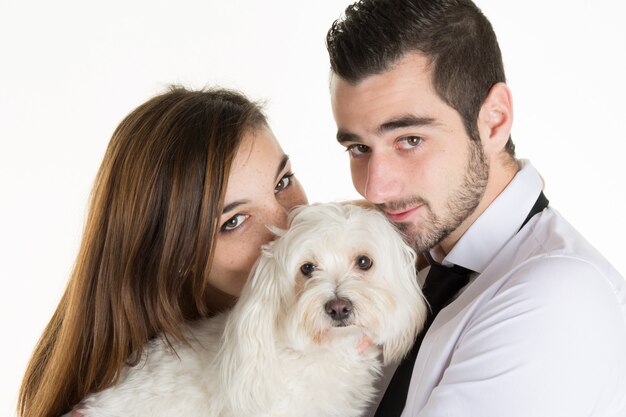 Portrait of happy couple with dog  over white