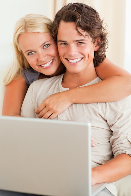 Portrait of a happy couple with a notebook