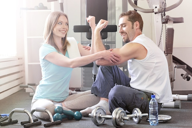 Portrait of  happy couple working out together in a gym